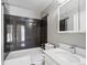 Updated bathroom with sleek black tile, modern vanity, and large mirror cabinet at 17990 E Cornell Dr, Aurora, CO 80013