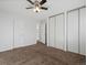 Spacious bedroom with plush carpet, a ceiling fan, and large closets for ample storage at 17990 E Cornell Dr, Aurora, CO 80013