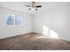 Cozy bedroom with a ceiling fan, natural light from the window and neutral carpeting at 17990 E Cornell Dr, Aurora, CO 80013