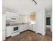 Bright kitchen features white cabinets, laminate floor, and lots of sunlight at 17990 E Cornell Dr, Aurora, CO 80013