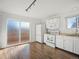 Clean kitchen with light wood floor, white cabinets, and stainless steel appliances at 17990 E Cornell Dr, Aurora, CO 80013