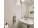 Half bathroom features pedestal sink, framed mirror, and neutral wall color at 4904 E 125Th Ave, Thornton, CO 80241