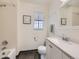 Bathroom features shower, window, and wood-look flooring at 4904 E 125Th Ave, Thornton, CO 80241