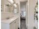 Bathroom with white vanity and sink; bedroom can be seen through doorway at 4904 E 125Th Ave, Thornton, CO 80241