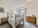 Bright bedroom with sliding glass door, metal frame bed, and wood dresser at 4904 E 125Th Ave, Thornton, CO 80241
