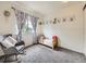 Bedroom features toddler bed, rocking chair, and neutral carpet at 4904 E 125Th Ave, Thornton, CO 80241