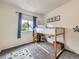Bedroom with loft bed, blue curtains, and alphabet rug at 4904 E 125Th Ave, Thornton, CO 80241