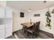 Charming dining area featuring a rustic wooden table and bench seating with elegant lighting at 4904 E 125Th Ave, Thornton, CO 80241