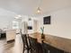 Bright dining area next to the kitchen featuring a modern wooden table and white cabinetry at 4904 E 125Th Ave, Thornton, CO 80241