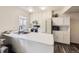 Bright kitchen with stainless steel appliances, white cabinetry, and a cozy window view at 4904 E 125Th Ave, Thornton, CO 80241