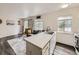 Bright open-concept view from the kitchen island through to the living room at 4904 E 125Th Ave, Thornton, CO 80241
