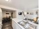 Spacious kitchen island with double sink overlooks the living room and dining area at 4904 E 125Th Ave, Thornton, CO 80241
