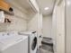 Laundry room with washer, dryer, and shelving for storage at 4904 E 125Th Ave, Thornton, CO 80241