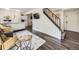 Open-concept living space with hardwood floors, a staircase, and modern design elements at 4904 E 125Th Ave, Thornton, CO 80241