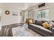 Cozy living room with modern decor, a comfortable sofa, and bright natural light at 4904 E 125Th Ave, Thornton, CO 80241