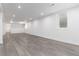 Bright basement showcasing stylish wood-look floors and a fresh, modern design with recessed lights at 5886 S Logan St, Centennial, CO 80121