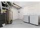 Finished basement laundry area featuring neutral color scheme and modern washer and dryer units at 5886 S Logan St, Centennial, CO 80121