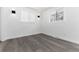 Minimalist bedroom with two windows, updated lighting fixtures, and wood-look flooring at 5886 S Logan St, Centennial, CO 80121
