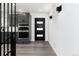 Modern entryway with gray cabinets, stainless appliances and stylish black accent door at 5886 S Logan St, Centennial, CO 80121
