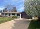 Single story house featuring a brown roof, brown two car garage door, and mature tree at 5886 S Logan St, Centennial, CO 80121