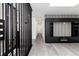 Hallway with black wood slat walls, and gray flooring at 5886 S Logan St, Centennial, CO 80121
