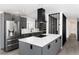 The kitchen features gray cabinets, stainless steel appliances, and an island with seating at 5886 S Logan St, Centennial, CO 80121