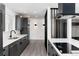 Modern kitchen boasts sleek gray cabinetry, stainless steel appliances, and a stylish black range hood at 5886 S Logan St, Centennial, CO 80121
