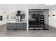 Modern kitchen features gray cabinets, stainless steel appliances, and a black range hood, offering a sleek and stylish design at 5886 S Logan St, Centennial, CO 80121