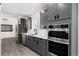 Modern kitchen featuring gray cabinets, stainless steel appliances, double ovens, and white countertops at 5886 S Logan St, Centennial, CO 80121
