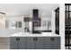 Modern kitchen featuring gray cabinets, stainless steel appliances, and a large island at 5886 S Logan St, Centennial, CO 80121