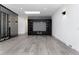 Modern living room with built in fireplace and decorative shelving with gray wood flooring at 5886 S Logan St, Centennial, CO 80121