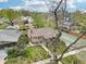 Aerial view showing the house with a tennis court surrounded by mature trees in a residential neighborhood at 925 S University Blvd, Denver, CO 80209