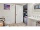 Compact bathroom features a toilet, pedestal sink, and doorway to storage space in a basement at 925 S University Blvd, Denver, CO 80209