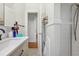 Well-lit bathroom features modern vanity, fixtures, and tile flooring, with access to an adjacent room at 925 S University Blvd, Denver, CO 80209