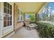 Relaxing front porch with a comfortable seating area and verdant vines creating a cozy outdoor space at 925 S University Blvd, Denver, CO 80209