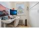 Dedicated home office space with multiple monitors, ergonomic chair, and natural light at 925 S University Blvd, Denver, CO 80209