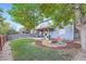 Large backyard with grass, fire pit, and deck at 7814 Club Crest Dr, Arvada, CO 80005