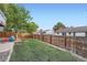 Landscaped backyard with grass and wood fence at 7814 Club Crest Dr, Arvada, CO 80005