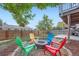 Backyard with fire pit and colorful seating at 7814 Club Crest Dr, Arvada, CO 80005