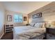 Bright bedroom with a comfortable bed and wood-like wall accents at 7814 Club Crest Dr, Arvada, CO 80005