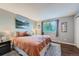 Spacious main bedroom with large window and plush bedding at 7814 Club Crest Dr, Arvada, CO 80005