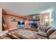 Living room with fireplace, large sectional sofa, and hardwood floors at 7814 Club Crest Dr, Arvada, CO 80005