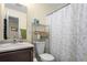 Cozy bathroom with a vanity, toilet, and shower with a decorative shower curtain at 2143 Coronado N Pkwy # C, Denver, CO 80229