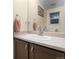 Bathroom vanity with dark wood cabinetry, a light countertop, and a mirror at 2143 Coronado N Pkwy # C, Denver, CO 80229