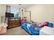 Cozy bedroom featuring carpet, window view, and colorful themed decor at 2143 Coronado N Pkwy # C, Denver, CO 80229