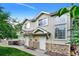Charming townhome featuring stone accents, a well-maintained lawn, and a welcoming entrance at 2143 Coronado N Pkwy # C, Denver, CO 80229
