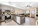 Bright kitchen featuring gray cabinetry, stainless steel appliances, and an island with a sink at 2143 Coronado N Pkwy # C, Denver, CO 80229