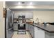 Bright kitchen featuring gray cabinetry, stainless steel appliances, and an island with a sink at 2143 Coronado N Pkwy # C, Denver, CO 80229