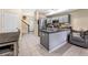 Bright kitchen layout with gray cabinets, stainless steel appliances, and an adjacent seating area at 2143 Coronado N Pkwy # C, Denver, CO 80229