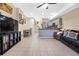 Open-concept living space with tiled floors connecting the kitchen, dining, and living areas at 2143 Coronado N Pkwy # C, Denver, CO 80229